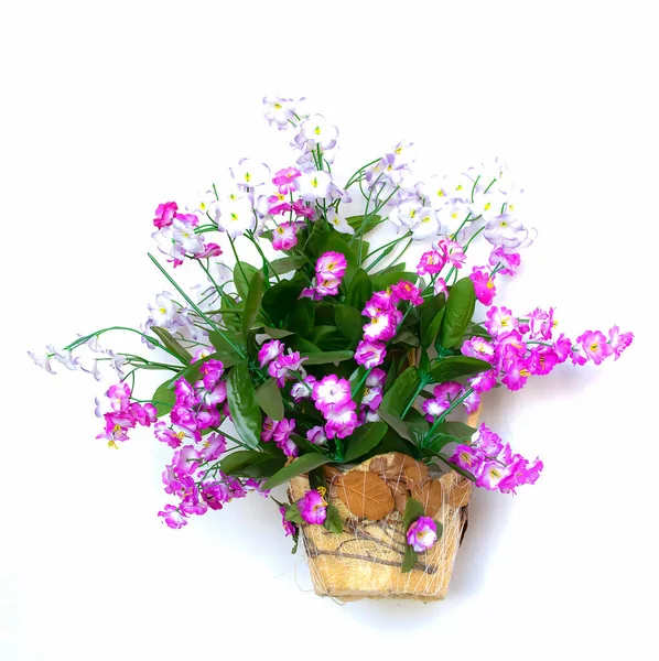 Artificial wild flowers on a white background. Flower basket with flowers as a design element