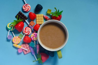 Bir fincan kahve, çikolata, şeker ve pamuk şekeri bir çerçeve gibi düzleştirildi.