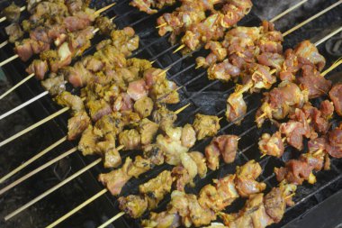 Close up shot of roasted goat satay, a popular dish in Indonesia.