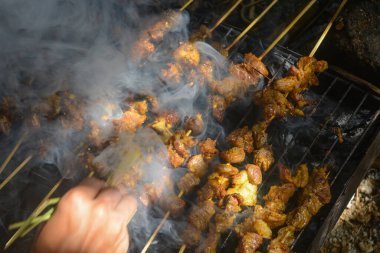 Close up shot of roasted goat satay, a popular dish in Indonesia.