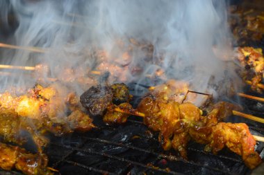 Close up shot of roasted goat satay, a popular dish in Indonesia.