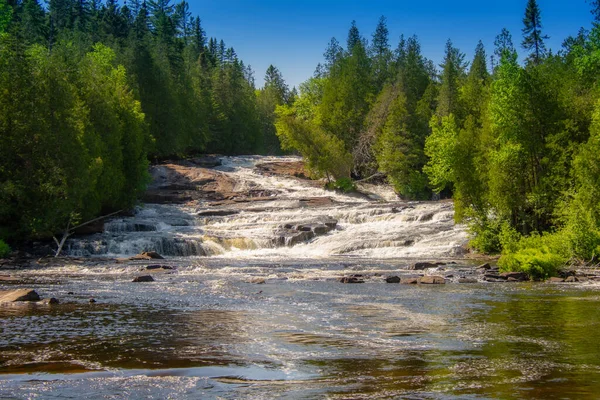 stock image Day time shot of river flowing in mountains among forest