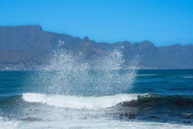 Cape Town 'daki kayalıklara çarpan dalgaların ve Güney Afrika' daki Robben Adası 'ndaki Masa' nın manzarası.