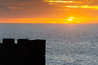 Sunset over the Atlantic above the Safi fortress in Morocco clipart