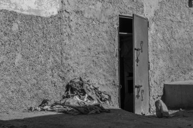 Siyah duvarlı eski bir kapının dikey görüntüsü.