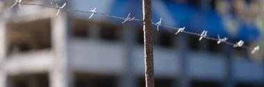 Barbed wire stretched over fence in prison. Freedom crime and prison sentence concept