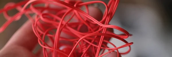 Tangled Red Headphones Hand Person Trying Unravel Broken Headphones Concept — стоковое фото