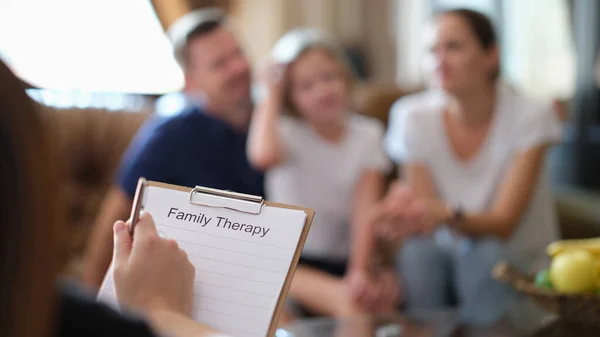 Close-up of psychologist at psychotherapy session with family in office. Psychology and family therapy concept