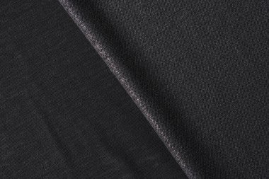 Siyah kumaş arka plan olarak kapanır. Siyah tekstil arkaplanı.