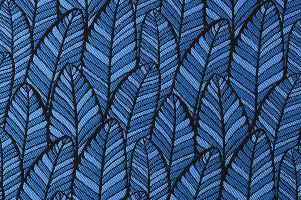 Blue fabric with leaves pattern. Close up of textile with tropical plant.