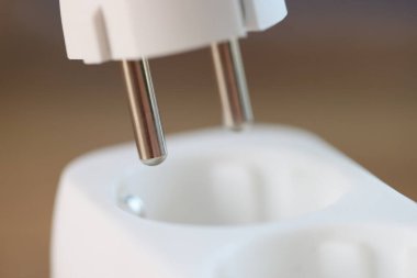 Plugging or unplugging electric plug into socket. Connecting and disconnecting electrical devices.