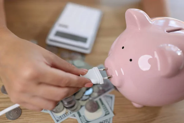 Close Woman Holding Power Plug Putting Charge Pink Piggy Bank — Stock Photo, Image