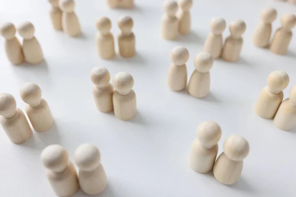 stock image Many couples of female and male wooden people figures on white background. Concept of homosexual and heterosexual relationships.