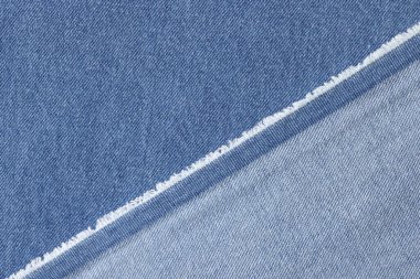 Arka plan olarak mavi kot kumaşı kesilmiş. Mavi kot kumaşın yüzü ve arkası.