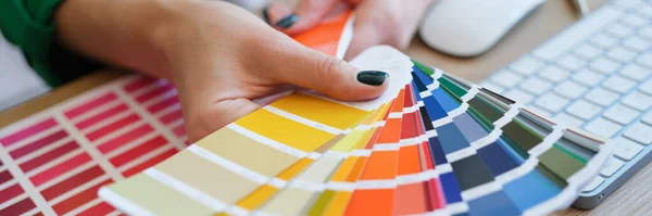 stock image graphic designer is working on choosing palette colors for creative business. Color selection in interior