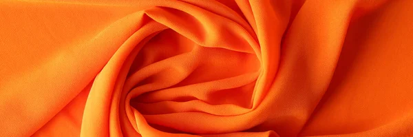 Orange texture of cotton or synthetic fabric. Fabric background