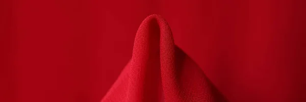 Red silk fabric. Synthetic fabric bright red color concept