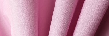 Arka plan ve tasarım çalışmaları için pembe kumaş dokusu üst görünümü. Katlama yüzey arka planında pembe tekstil