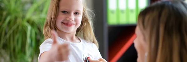 一个快乐的微笑的女孩在儿科医生的预约中的画像 小孩露出大拇指向上的姿势 儿科和医学概念 — 图库照片