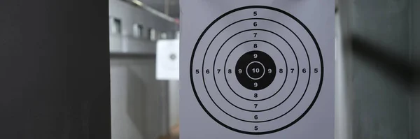 Close-up of target with numbers for shooting at rifle range. Round target with marked bulls-eye for shooting practice on range