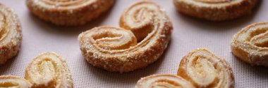 Top view of yummy puff pastry cookies with sugar sprinkle. Home cooking desserts and bakery products concept