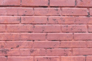 Arka plan olarak kırmızı renge boyanmış tuğla bina. Mimarlık ve tasarım şehir için idealdir. Eski kentte dış döşemeli tuğla duvar yüzeyi