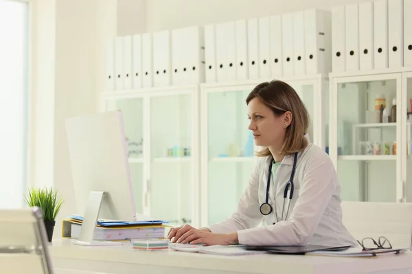 Kvinnlig Anställd Inom Medicinen Med Stetoskop Fyller Patientuppgifter Datorn Arbetsplatsen — Stockfoto