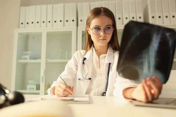 Koncentrerad Läkare Glasögon Undersöker Röntgen Patienten Sitter Vid Bordet Kliniken — Stockfoto