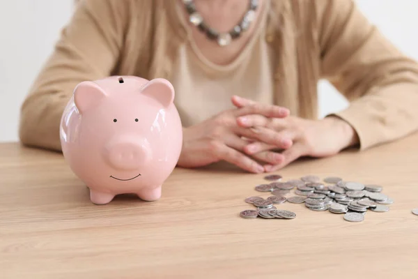 Pink Piggy Bank Bunch Coins Wooden Table Woman Folded Hands — Stock Photo, Image