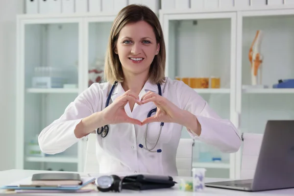 Positive Doctor Shows Heart Hands Sitting Workplace Clinic Office Concept — Stock Photo, Image