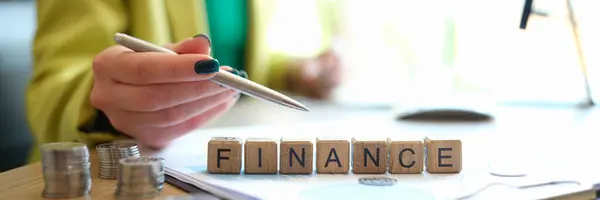 Close Woman Pointing Word Finance Collected Wooden Blocks Row Business — Stockfoto