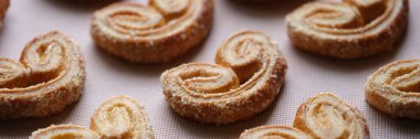 Close-up of delicious puff pastry cookies with sugar sprinkles. Home cooking desserts and bakery products concept