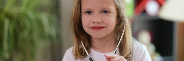 Portrait Smiling Little Girl Using Medical Stethoscope Pointing Finger Somebody — Zdjęcie stockowe