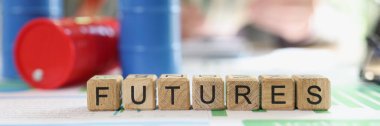 Oil futures and trading concept. Word futures collected from wooden cubes and oil barrels on financial statements, business man with money in background.