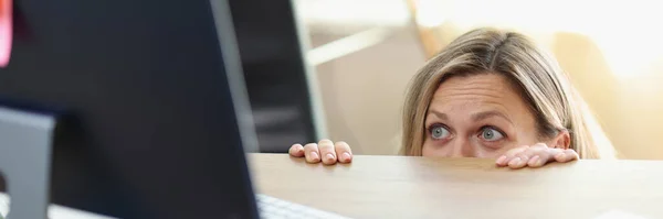 Scared Female Manager Hidden Office Desk Looking Computer Screen Unwanted — Zdjęcie stockowe
