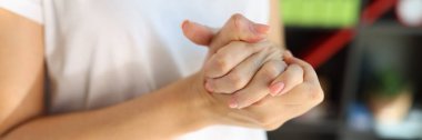 Woman suffering because pain in her hands. Close up of female massaging her overworked hands. Health problems concept.