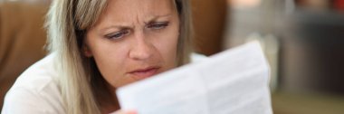 Portrait of serious woman reading instructions for medical use of medicines. Healthcare, treatment and medicine concept