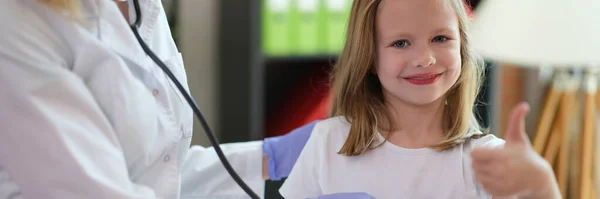 Female Doctor Examines Happy Young Patient Hospital Stethoscope Girl Shows — Zdjęcie stockowe