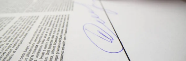 Woman signs contract papers with pen showing agreement with rules. Female person puts personal signature above line on paper sheet