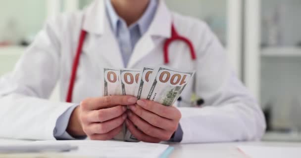 医師のセラピストまたはプラスチック外科医は 医療クリニックで手元にお金をカウントします 医薬品や健康保険のコストや医薬品の賄賂の腐敗 — ストック動画