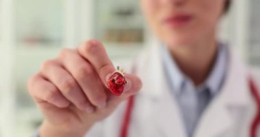 Kardiyolog, kırmızı kalp ikonunu elinde tutuyor. Kalp hastalığı teşhisi ve tedavisi