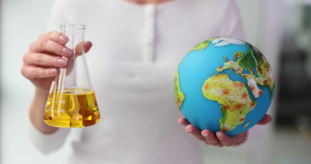 Woman Holds Flask Yellow Oil Globe Environmental Problems Oil Industry — Stock Video