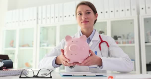 医生治疗师 手上拿着粉红猪油罐在诊所里昂贵的医疗程序和对健康和健康保险费用的投资 — 图库视频影像