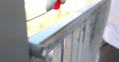 Gri boyalı silindirli metal bir boru boyuyorum. Kendiniz yapın. Balkon parmaklıklarını boyayın.