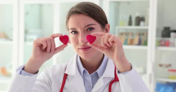 Female Cardiologist Doctor Closes Two Heart Eyes Rehabilitation Patients Heart — Stock Video