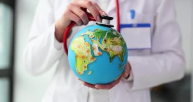 Steteskopla dünyayı dinleyen doktorlara yakın çekim. Dünya virüsü ve salgın