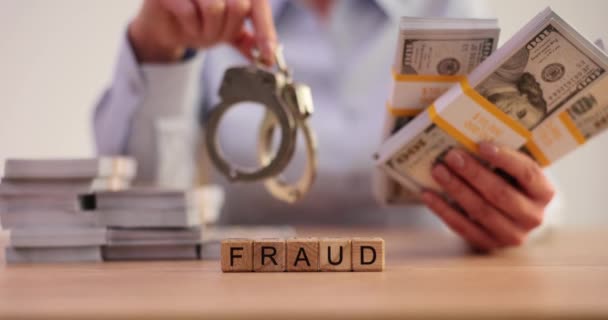 Criminal Holding Handcuffs Dollar Bills Word Fraud Financial Crimes Bribery — Stock Video