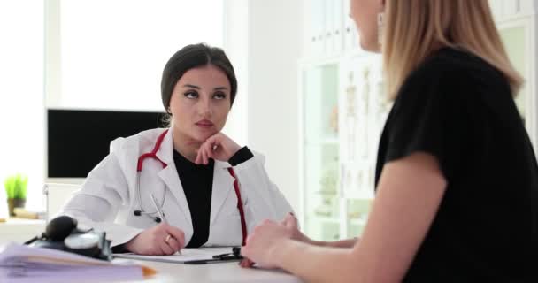 Vrouwelijke Arts Maakt Aantekeningen Tijdens Een Ontmoeting Met Patiënt Raadpleging — Stockvideo