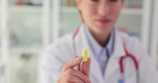 Female Medic Shows Yellow Earplug Use Deep Sleep Concept Thing — Stock Video