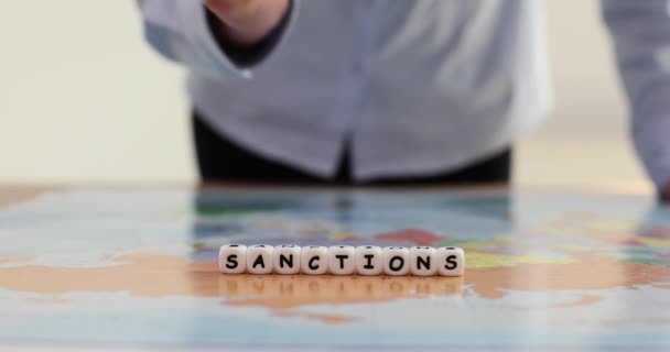 Hand Knocking Table Fist World Map Word Sanctions Closeup Movie — Stock Video